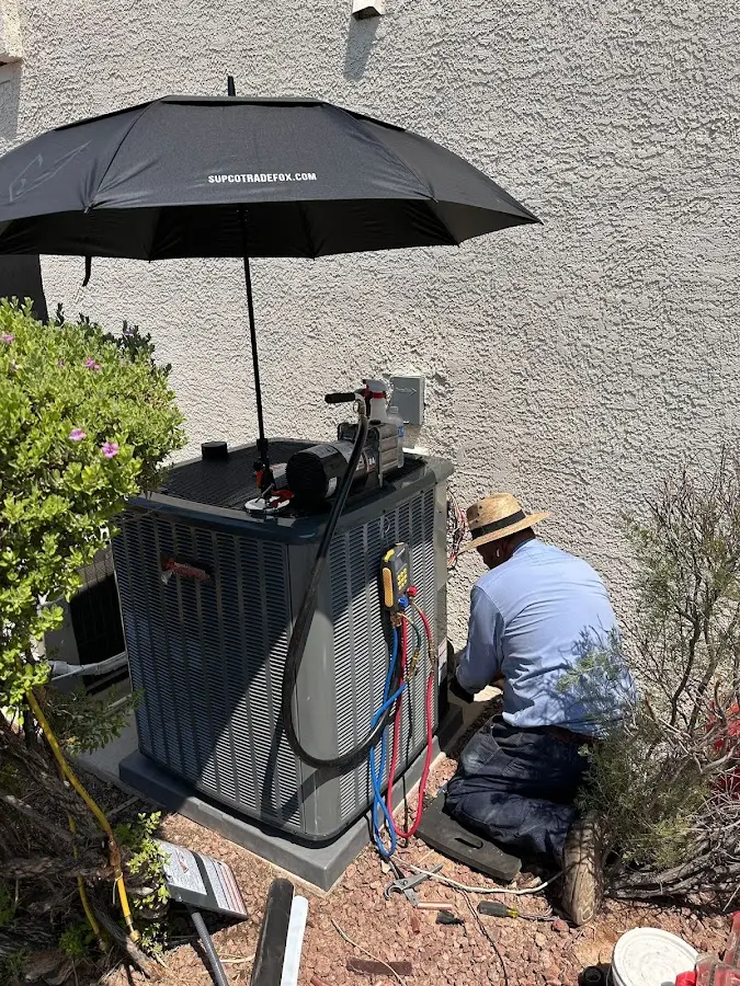 HVAC technician performing outdoor AC maintenance in Cedar Hill